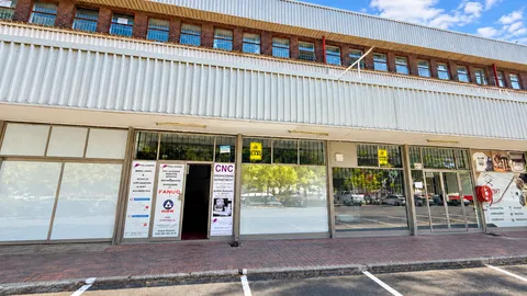 Modern Industrial Storefront Under Blue Skies.png