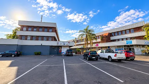 Vibrant Suburban Plaza Parking Lot.png