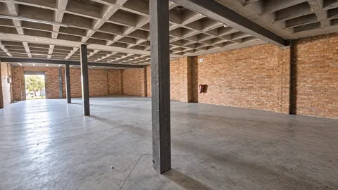 Empty Industrial Warehouse Interior.png